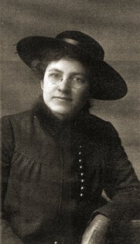 Margaret Young Stafford, a mature woman in an elegant black hat, fur-trimmed dark blouse, and dark kid gloves