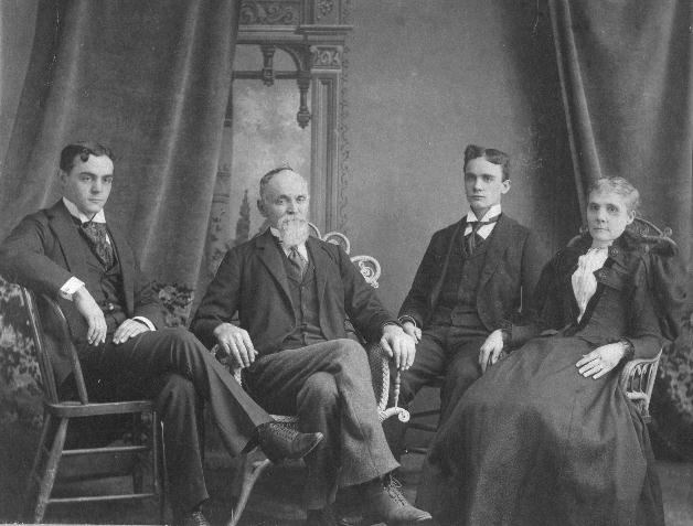Addison tries to look casual, but David, Frank T. and Emma sit very straight and very formal in this studio photograph