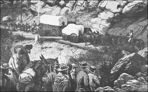 [Wagons struggling up a narrow mountain road.]
